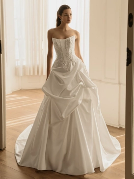 ÉLYSÉE Bridal HAVEN luxury satin fit-and-flare wedding dress featuring a strapless scoop neckline, embellished corset bodice, dramatic draped overskirt and sweeping cathedral train.