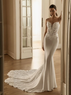 HENLEIGH by ÉLYSÉE is a fitted crepe mermaid wedding dress featuring a sheer floral lace corset bodice, delicate spaghetti straps, a plunging neckline, and an elegant lace cathedral train.