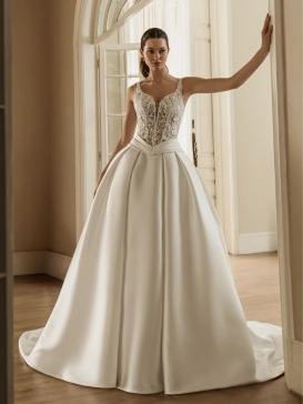 HERA by ÉLYSÉE is a couture ball gown wedding dress featuring a sheer floral lace corset bodice with wide straps and a dramatic Mikado skirt for timeless bridal elegance.